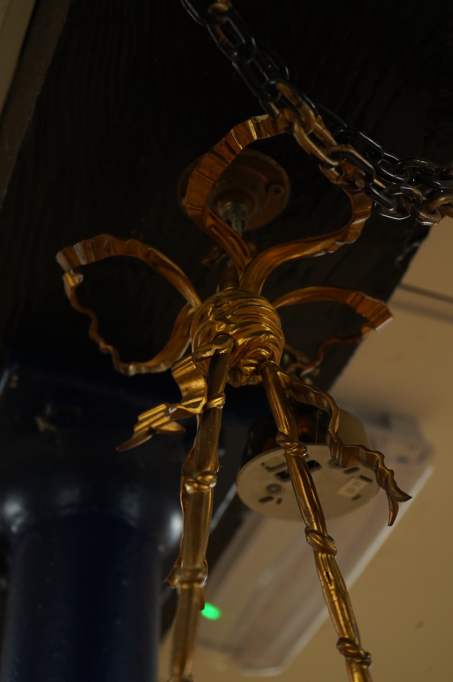 A gilt metal chandelier in the form of a cherub in a basket, 65cm high. Condition - fair, untested